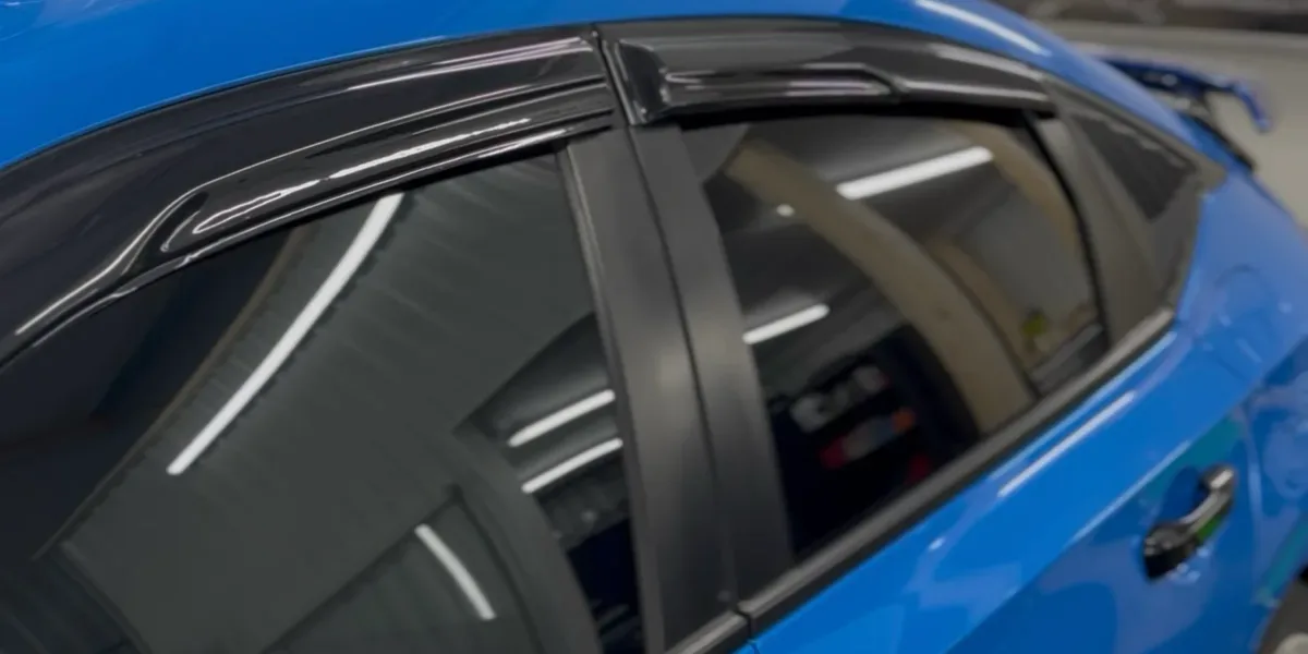 Tinted side glass on a blue hatchback at DC Custom Wraps